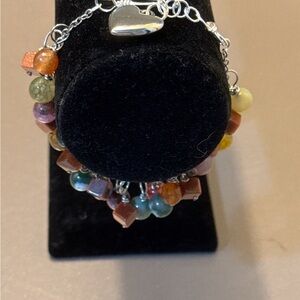 Adjustable silver bracelet an array of natural colorful gemstones with a heart